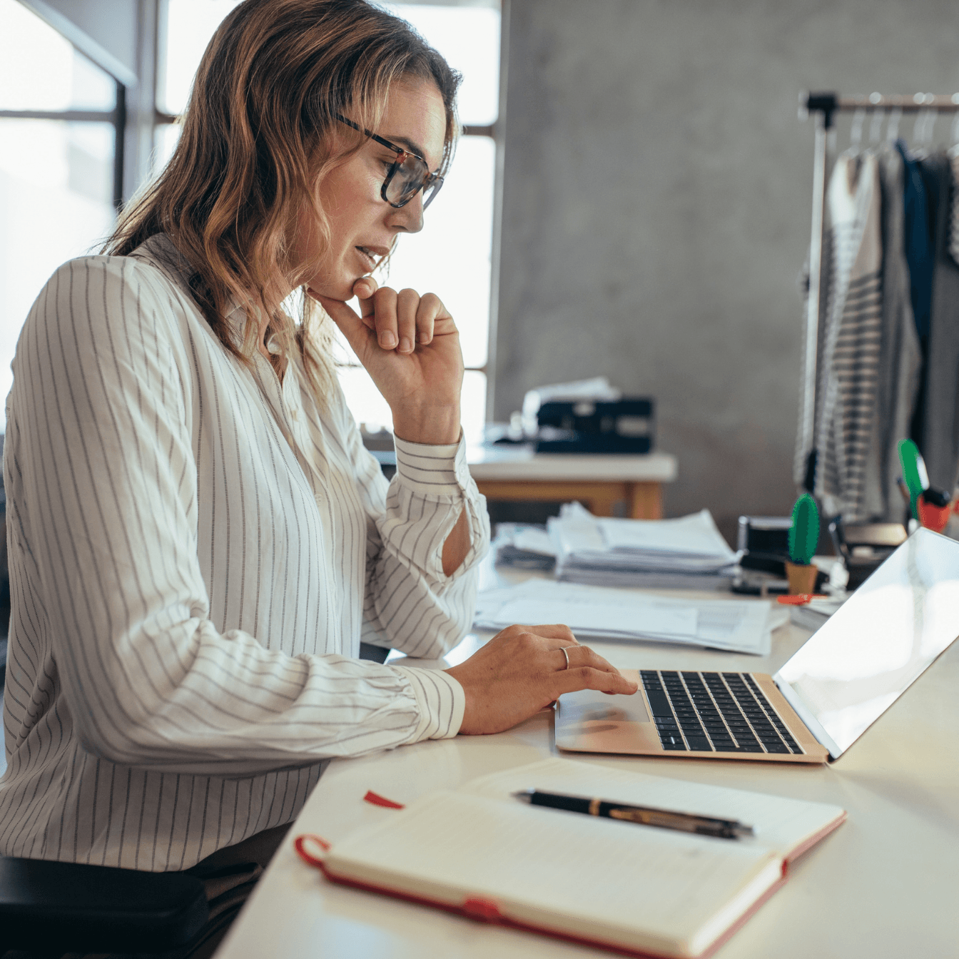 A business owner reviewing her books at her desk